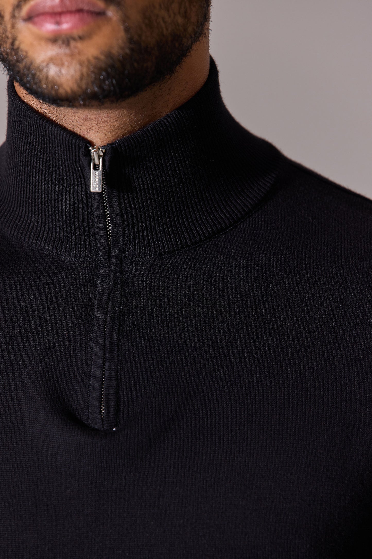 Close up-black long sleeve with zip collar polo shirt for men. Maklin Clothing.